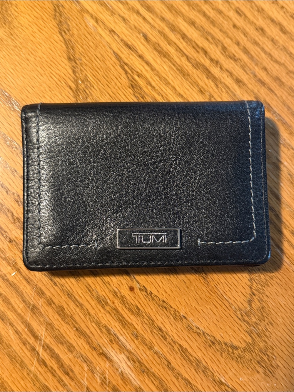 Tumi Black Leather Bi-fold wallet with Silver Logo Plate